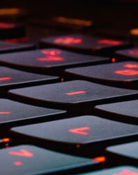 Close-up of a black keyboard with glowing red letters